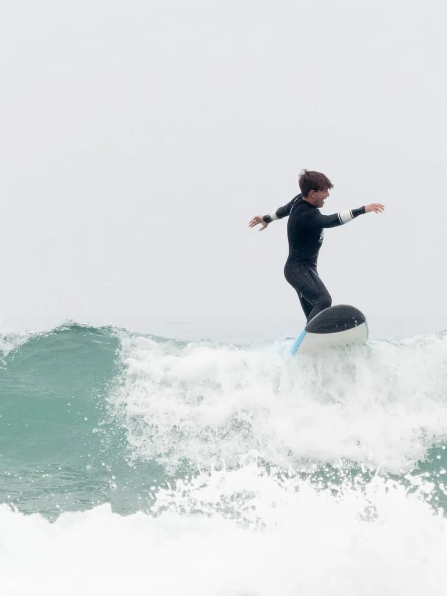 A surfer riding a clean Atlantic wave in Tamraght