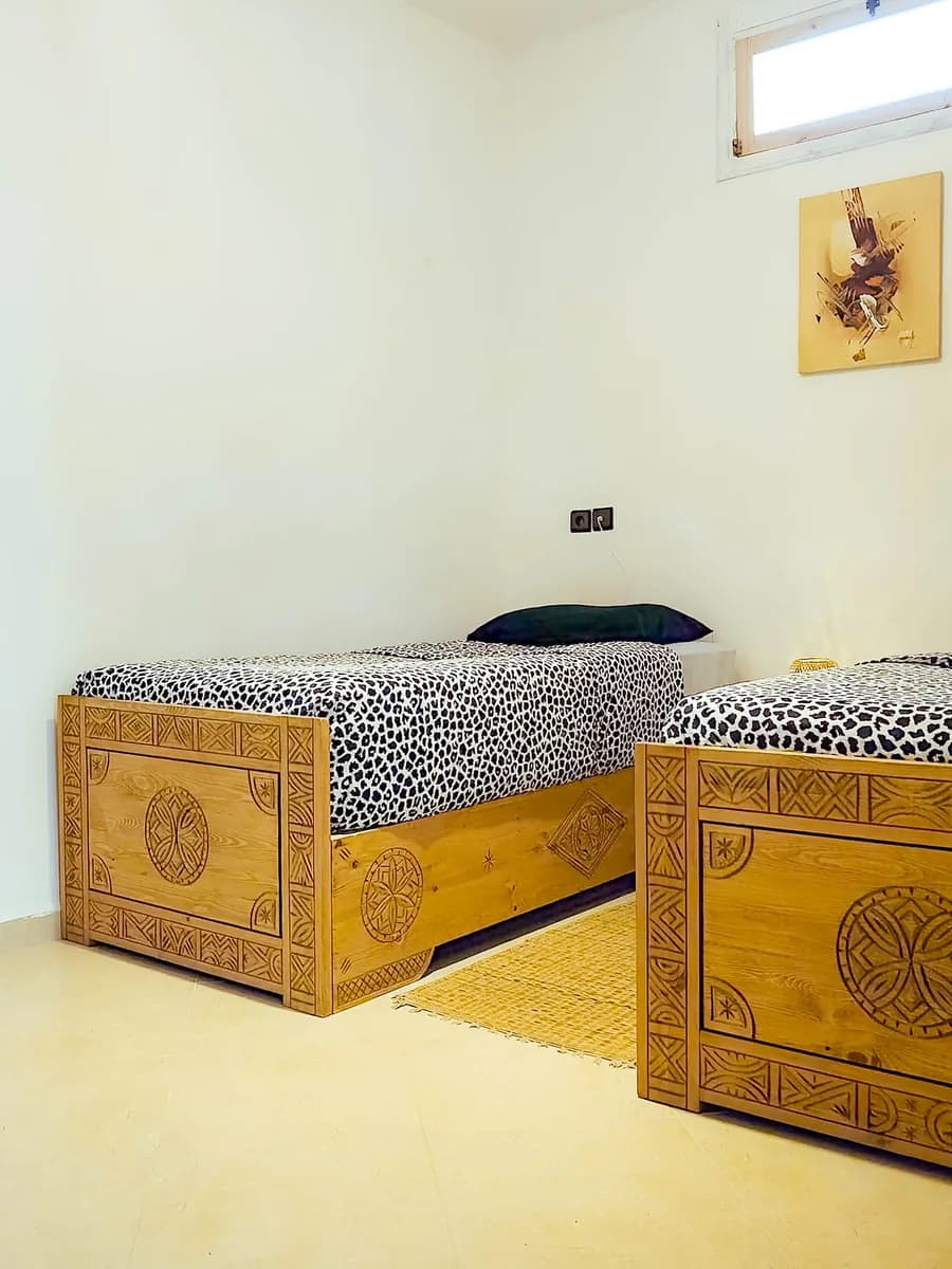 Cozy Moroccan bedroom with handcrafted wooden beds