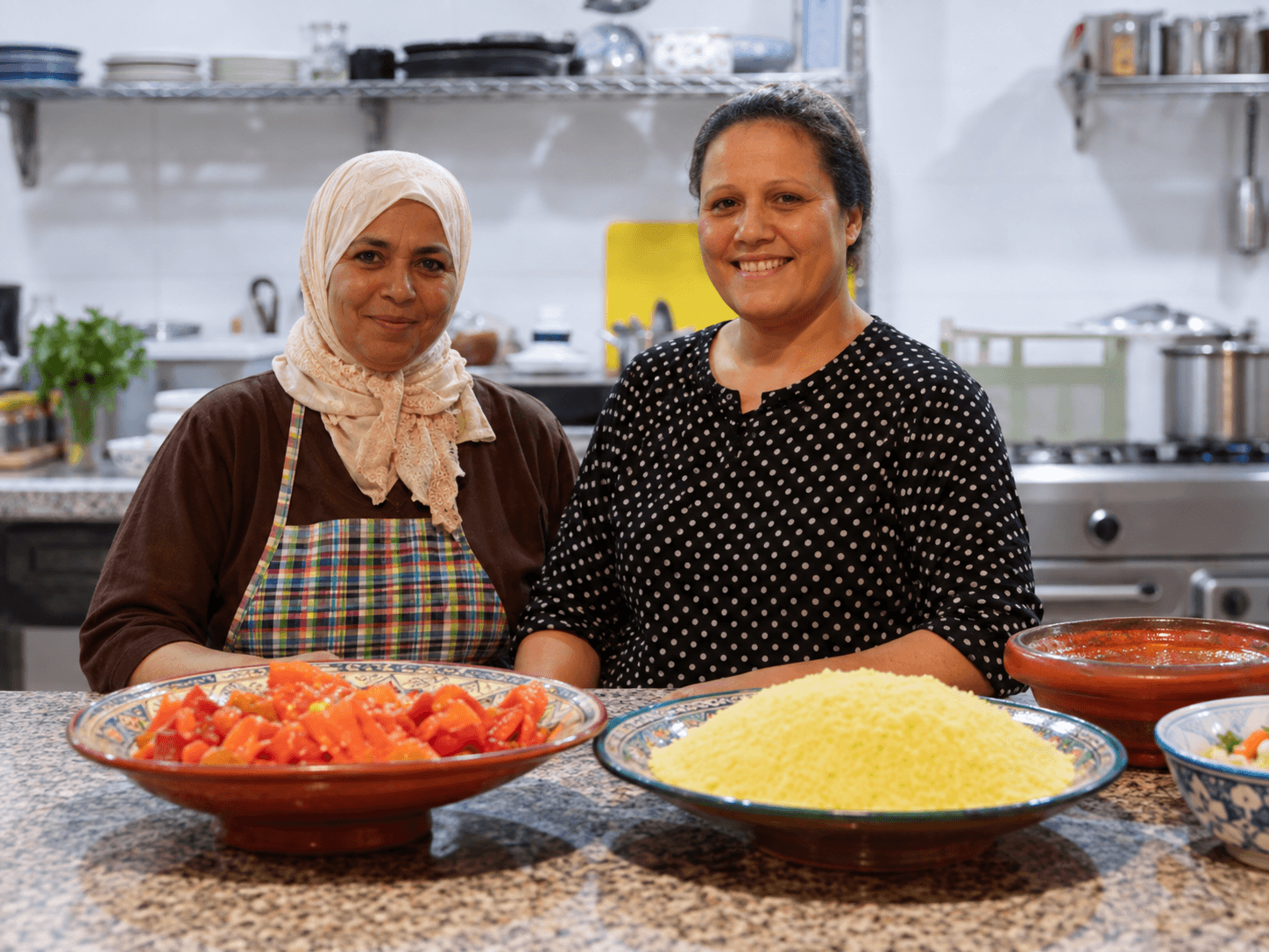 Miriam and Zara preparing a meal in the surf house kitchen